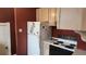 Functional kitchen with essential appliances, storage cabinets, and a neutral countertop for easy maintenance at 1653 Trenton St, Denver, CO 80220