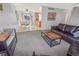 Inviting living room with plush seating, view to the kitchen, and plenty of natural light at 18971 E Mercer Dr, Aurora, CO 80013