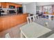 Open-concept living area with kitchen featuring wood cabinets, island, and cozy living room at 18971 E Mercer Dr, Aurora, CO 80013