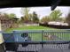 View from the blue deck overlooking a green yard with garden beds and mature trees at 865 S Depew St, Lakewood, CO 80226