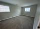 This cozy bedroom features two windows and plush gray carpeting at 865 S Depew St, Lakewood, CO 80226