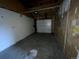 Unfinished garage area with raw walls and a white door at 865 S Depew St, Lakewood, CO 80226