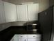 Kitchenette space featuring white cabinets and stainless steel microwave at 865 S Depew St, Lakewood, CO 80226