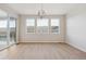 A spacious dining room with hardwood floors, large windows, and sliding glass doors to the outside deck at 3350 Backdrop Ct, Castle Rock, CO 80108