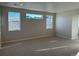 Bright living room features neutral walls, carpet and three large picture windows at 3350 Backdrop Ct, Castle Rock, CO 80108