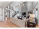 Bright living room featuring hardwood floors, two-story ceilings, modern fireplace and staircase at 3350 Backdrop Ct, Castle Rock, CO 80108