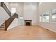 Spacious living room with wood floors, staircase, and natural light at 3350 Backdrop Ct, Castle Rock, CO 80108