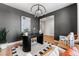 Home office featuring a dark color scheme, modern lighting, and hardwood floors at 3350 Backdrop Ct, Castle Rock, CO 80108