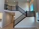 A light-filled view of the two-story foyer with dark wood staircase and railing at 3350 Backdrop Ct, Castle Rock, CO 80108