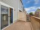 Back deck showing railing, privacy fence, and sliding glass doors leading to the interior at 1699 S Trenton St # 172, Denver, CO 80231