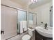 Bathroom featuring a glass shower door, dark vanity, and decorative accents at 1699 S Trenton St # 172, Denver, CO 80231