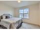 Bright bedroom featuring a large window that lets in natural light and plush carpet at 1699 S Trenton St # 172, Denver, CO 80231