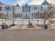 Charming townhomes featuring a mix of blue and gray exteriors, each with a garage and well-maintained landscaping at 1699 S Trenton St # 172, Denver, CO 80231