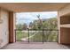 Balcony view of green spaces, walking path, and building exterior at 303 Inverness Way # 201, Englewood, CO 80112