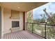 Balcony with a fireplace overlooking a lawn, trees, and walking path at 303 Inverness Way # 201, Englewood, CO 80112