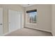 Bedroom features carpeted floor, a closet and a window with outside views at 303 Inverness Way # 201, Englewood, CO 80112