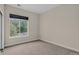 This bedroom features carpet and a window with greenery views at 303 Inverness Way # 201, Englewood, CO 80112