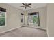 Bedroom featuring neutral walls, carpet, a ceiling fan and three windows allowing lots of natural light at 303 Inverness Way # 201, Englewood, CO 80112