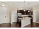 Modern kitchen with stainless steel appliances, dark wood cabinets, granite countertops and a kitchen island at 303 Inverness Way # 201, Englewood, CO 80112