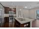 View of the kitchen and dining area, stainless appliances, dark wood cabinets, and hardwood floors at 303 Inverness Way # 201, Englewood, CO 80112