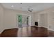 Bright living room with sliding doors to the balcony and a ceiling fan at 303 Inverness Way # 201, Englewood, CO 80112