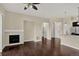 Open-concept living room with a fireplace, hardwood floors, and modern finishes at 303 Inverness Way # 201, Englewood, CO 80112
