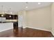 Spacious living room with hardwood floors, ample natural light, and view into the kitchen area at 303 Inverness Way # 201, Englewood, CO 80112