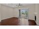 Open living room with a sliding glass door and plenty of natural light at 303 Inverness Way # 201, Englewood, CO 80112