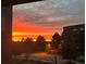 Balcony with sunset view overlooking trees and nearby streets at 303 Inverness Way # 201, Englewood, CO 80112