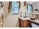 Well-lit powder room featuring neutral colors, tiled countertops, and decorative accents at 10968 Macon St, Commerce City, CO 80640