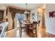 Inviting dining area featuring hardwood floors and a view to the outside through a sliding glass door at 10968 Macon St, Commerce City, CO 80640