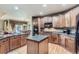 Spacious kitchen featuring custom cabinetry, granite countertops, stainless steel appliances, and hardwood floors at 10968 Macon St, Commerce City, CO 80640