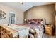 Spacious main bedroom features rustic wood furniture, soft lighting, and an ensuite bathroom at 10968 Macon St, Commerce City, CO 80640