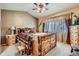 Cozy main bedroom features rustic wood furniture, soft lighting, and stylish decor at 10968 Macon St, Commerce City, CO 80640