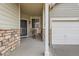 Cozy covered porch with seating area, perfect for relaxing outdoors, adjacent to the two-car garage at 10968 Macon St, Commerce City, CO 80640