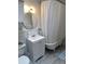 Bright bathroom featuring a vanity sink, round mirror, and claw foot bathtub with a shower curtain at 1038 E 4Th Ave, Denver, CO 80218