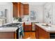 Kitchen featuring a gas range, island, and a farmhouse sink at 1038 E 4Th Ave, Denver, CO 80218