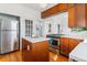 Open kitchen with stainless appliances, island and classic wood cabinets at 1038 E 4Th Ave, Denver, CO 80218