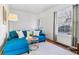 Bright living room with hardwood floors, a large window, and stylish blue sofa at 1038 E 4Th Ave, Denver, CO 80218