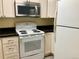 Bright apartment kitchen with white cabinets and modern appliances at 3124 S Wheeling Way # 102, Aurora, CO 80014