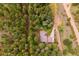 Lovely aerial view of a home tucked away in a thick forest with a long driveway at 25808 Sunrise Ln, Golden, CO 80401
