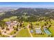 Aerial view of the property and community with tennis courts and parking lot at 25808 Sunrise Ln, Golden, CO 80401