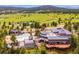 Aerial view of the property with a pool, sports courts, and beautiful landscaping at 25808 Sunrise Ln, Golden, CO 80401