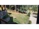 View of the backyard with beautiful natural landscaping and deer grazing on the lawn at 25808 Sunrise Ln, Golden, CO 80401