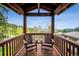 Cozy covered balcony with comfortable seating and scenic views of the surrounding nature at 25808 Sunrise Ln, Golden, CO 80401