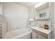 Bathroom with tub and sink with white tile and fixtures at 25808 Sunrise Ln, Golden, CO 80401
