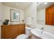 Half bath with oak cabinets, and a vessel sink at 25808 Sunrise Ln, Golden, CO 80401
