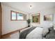 Bedroom with tree views out multiple windows and a corner window at 25808 Sunrise Ln, Golden, CO 80401