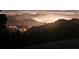 View of the city lights from a high point with mountains at 25808 Sunrise Ln, Golden, CO 80401