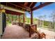 Charming covered patio with stone accents and wooden beams, offering a serene outdoor space with views of the surrounding landscape at 25808 Sunrise Ln, Golden, CO 80401